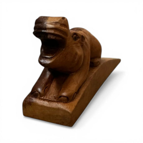 Handcrafted wooden hippopotamus door stop with an open-mouth design and rich natural finish. This functional decorative door wedge adds a playful African-inspired touch to modern, rustic, safari, or farmhouse home interiors.