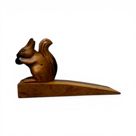 Handcrafted wooden squirrel door stop featuring a charming squirrel holding an acorn, finished in rich natural wood tones. This decorative door wedge combines functionality with whimsical style, making it perfect for modern, rustic, woodland, or farmhouse home décor.