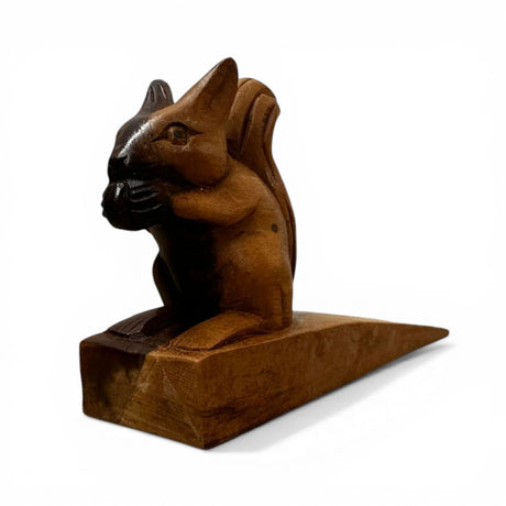 Handcrafted wooden squirrel door stop featuring a charming squirrel holding an acorn, finished in rich natural wood tones. This decorative door wedge combines functionality with whimsical style, making it perfect for modern, rustic, woodland, or farmhouse home décor.