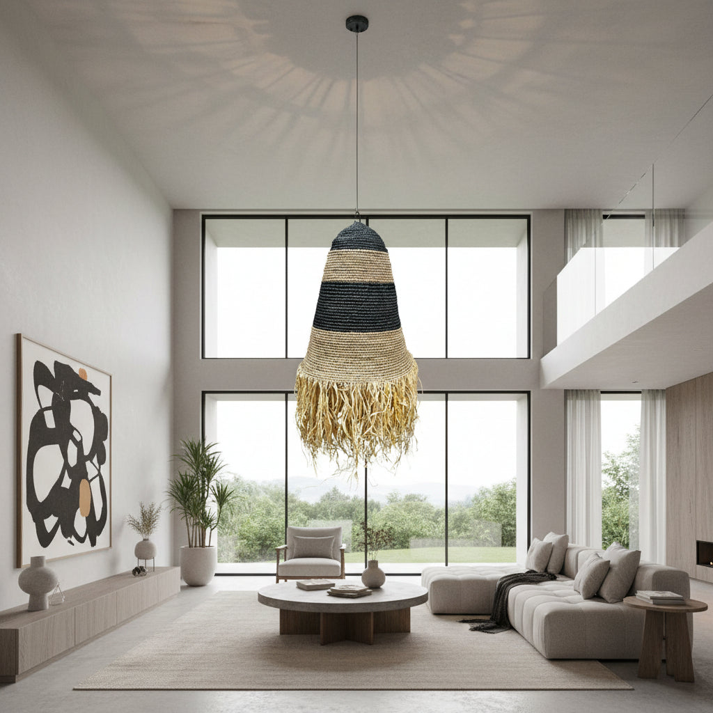 Handwoven pendant light featuring black and natural woven bands with a tapered silhouette and decorative fringe, creating warm ambient lighting and a relaxed bohemian statement for dining rooms, bedrooms, living spaces, or covered patios.