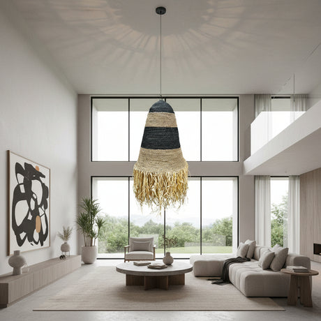 Handwoven pendant light featuring black and natural woven bands with a tapered silhouette and decorative fringe, creating warm ambient lighting and a relaxed bohemian statement for dining rooms, bedrooms, living spaces, or covered patios.