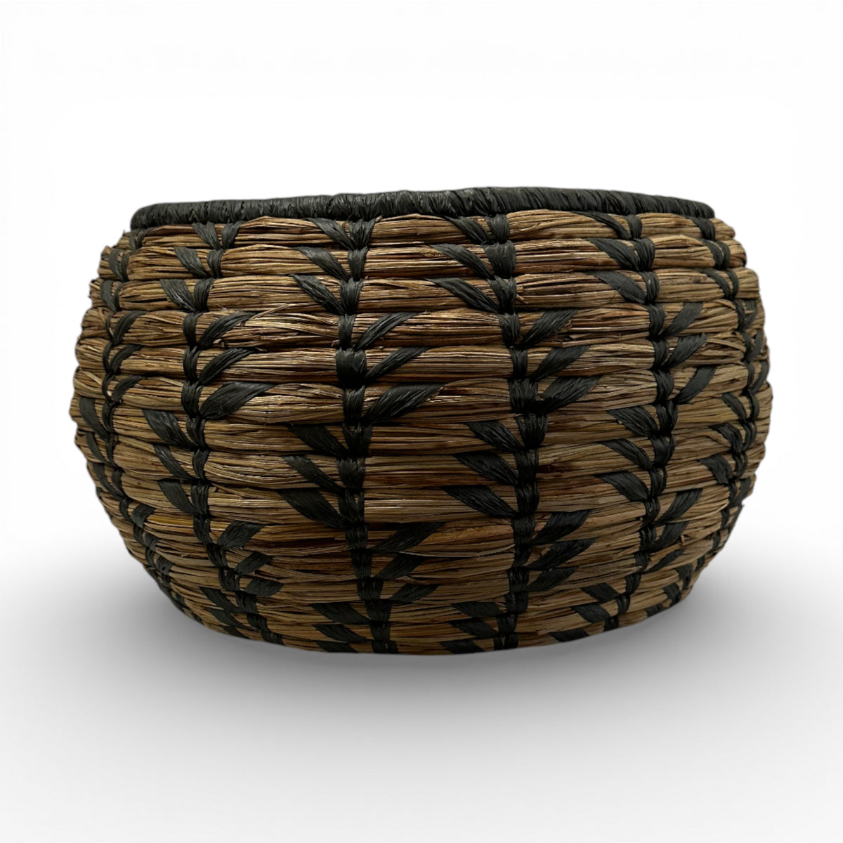 Handwoven decorative basket featuring natural seagrass with a bold black geometric pattern and rounded silhouette, perfect for organising small household items or adding artisanal texture and contemporary bohemian style to shelves, coffee tables, or consoles.
