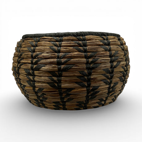 Handwoven decorative basket featuring natural seagrass with a bold black geometric pattern and rounded silhouette, perfect for organising small household items or adding artisanal texture and contemporary bohemian style to shelves, coffee tables, or consoles.
