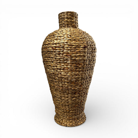 Handwoven natural decorative floor vase with a sculptural tapered silhouette, narrow neck, and richly textured woven finish, perfect for displaying pampas grass, dried botanicals, or decorative branches in contemporary, coastal, or organic-inspired interiors.