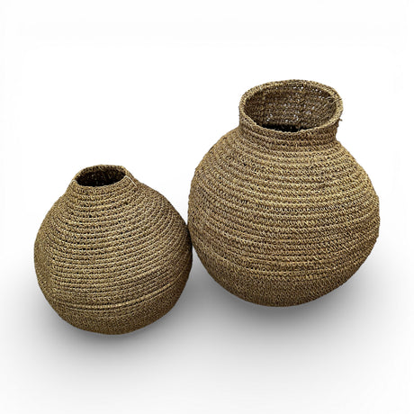 Set of two handwoven natural decorative vases with sculptural rounded silhouettes and textured woven finishes, perfect for displaying dried botanicals or adding warm organic texture to contemporary, coastal, or rustic interiors.