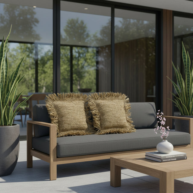 Handwoven natural scatter cushions with textured woven fabric and decorative fringe edging, styled on a contemporary outdoor sofa to add warm organic texture, relaxed comfort, and timeless coastal elegance to patios and outdoor living spaces.