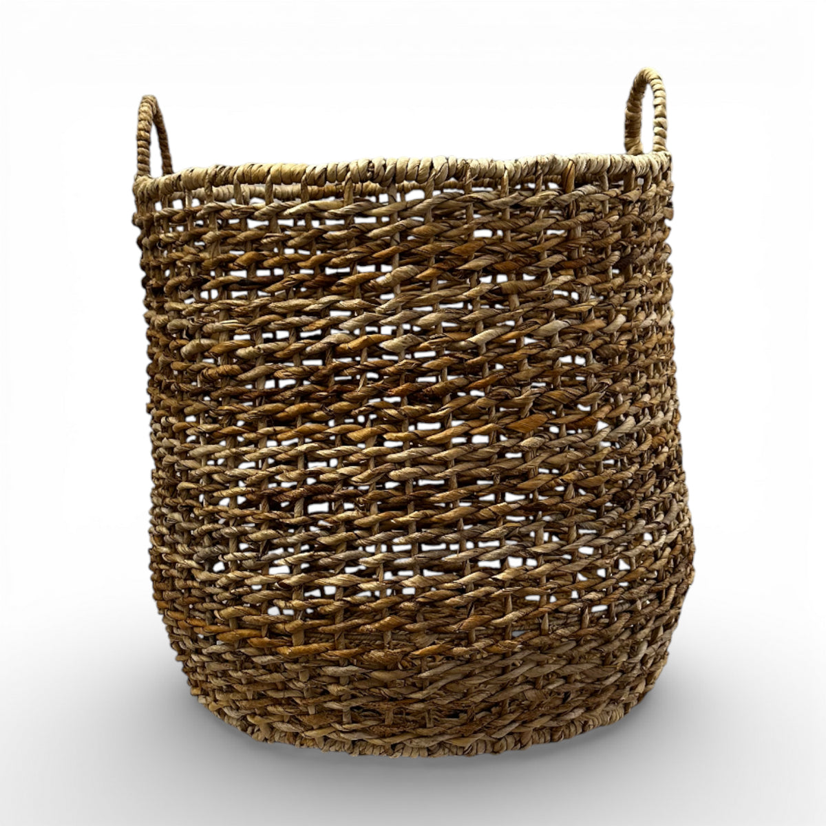Handwoven natural storage basket with an open-weave design, integrated carry handles, and a soft organic silhouette, perfect for storing blankets, cushions, toys, or everyday essentials while adding warm texture and timeless artisanal style to contemporary, coastal, and rustic interiors.