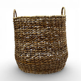 Handwoven natural storage basket with an open-weave design, integrated carry handles, and a soft organic silhouette, perfect for storing blankets, cushions, toys, or everyday essentials while adding warm texture and timeless artisanal style to contemporary, coastal, and rustic interiors.