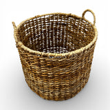 Handwoven natural storage basket with an open-weave design, integrated carry handles, and a soft organic silhouette, perfect for storing blankets, cushions, toys, or everyday essentials while adding warm texture and timeless artisanal style to contemporary, coastal, and rustic interiors.