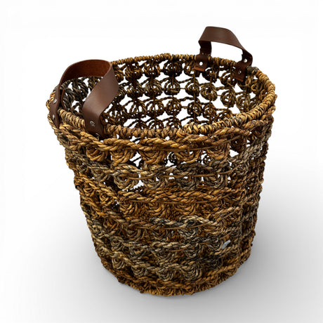 Handwoven open-weave storage basket with rich natural fibres and genuine leather carry handles, perfect for storing blankets, cushions, magazines, or everyday essentials while adding warm organic texture and contemporary artisanal style to modern, coastal, and rustic interiors.