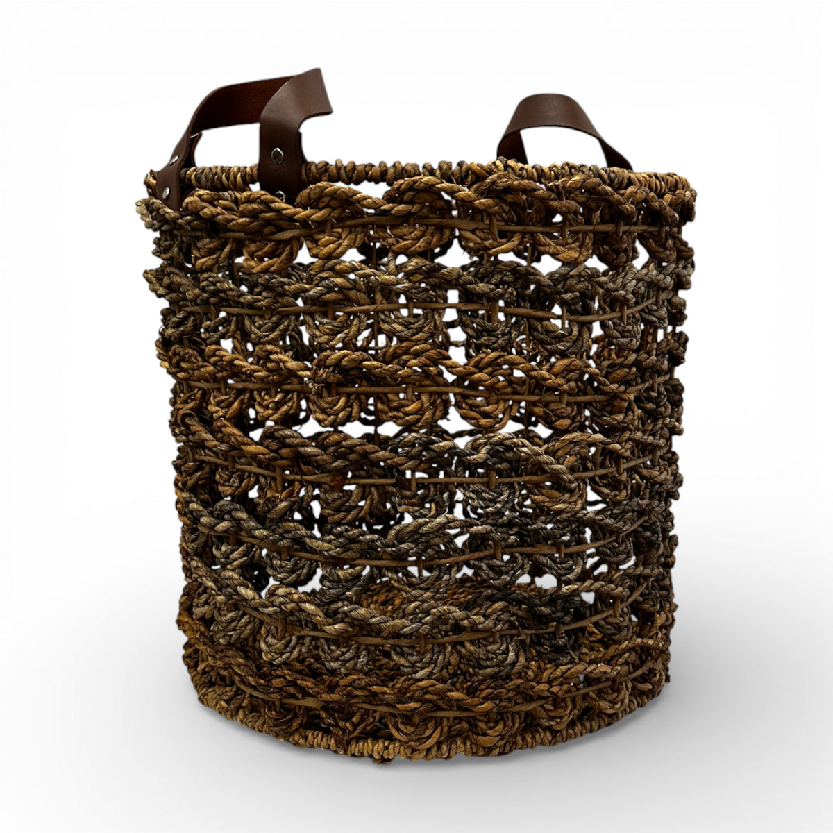 Handwoven open-weave storage basket with rich natural fibres and genuine leather carry handles, perfect for storing blankets, cushions, magazines, or everyday essentials while adding warm organic texture and contemporary artisanal style to modern, coastal, and rustic interiors.