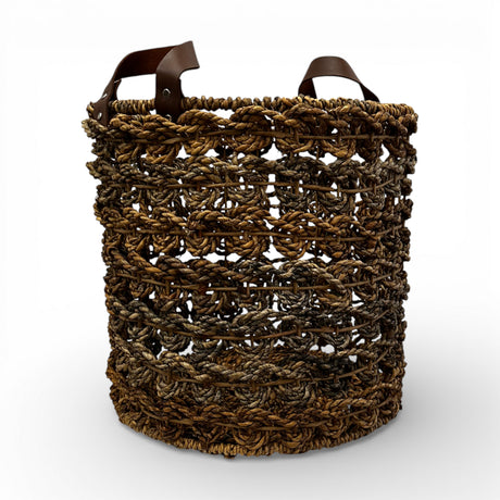 Handwoven open-weave storage basket with rich natural fibres and genuine leather carry handles, perfect for storing blankets, cushions, magazines, or everyday essentials while adding warm organic texture and contemporary artisanal style to modern, coastal, and rustic interiors.