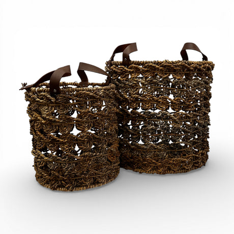 Set of two handwoven open-weave storage baskets with rich natural fibres and genuine leather handles, offering stylish storage for blankets, plants, or everyday essentials while adding organic texture and contemporary artisanal charm to modern, coastal, and rustic interiors.