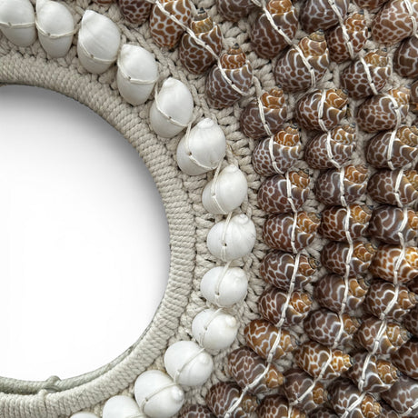 Close-up detail of a handcrafted decorative wall mirror featuring a handwoven natural fibre frame embellished with white and patterned seashells. The intricate craftsmanship and coastal-inspired design create a luxurious bohemian statement piece for living rooms, bedrooms, entryways, boutique hotels, or beach-style interiors.