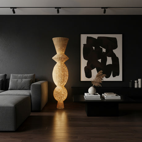 Tall sculptural floor lamp featuring a handwoven natural wicker shade with an elegant stacked silhouette that softly diffuses warm ambient light. A striking statement lighting piece perfect for living rooms, bedrooms, boutique hotels, and contemporary interiors.