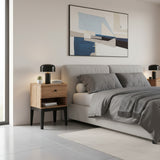 Modern bedroom with a bed, nightstands, and abstract art on the wall.