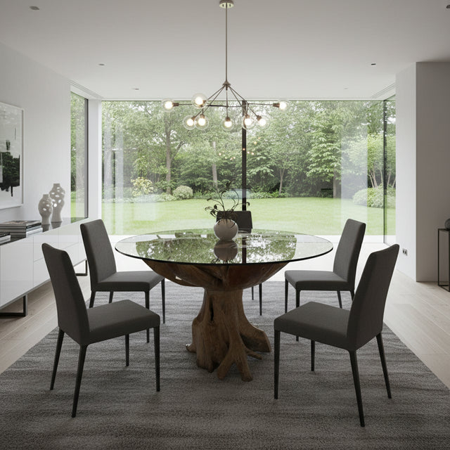 Contemporary round glass dining table featuring a sculptural solid wood tree root pedestal base with a natural finish. A striking statement piece that combines organic craftsmanship with modern elegance, ideal for dining rooms, lodges, luxury homes, or contemporary interiors.