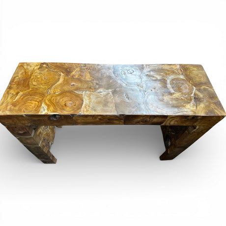 Handcrafted reclaimed wood console table featuring a natural live-edge design, richly detailed wood grain, and sculptural cut-out legs, viewed from above to showcase the unique organic timber patterns.