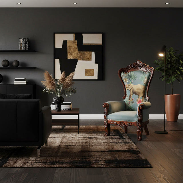 Luxury accent chair featuring a hand-carved dark wood frame, soft sage green upholstery, and a decorative high back showcasing an elegant elephant illustration with botanical details. A timeless statement piece for sophisticated living spaces, boutique hotels, or executive lounges.