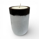 Handcrafted candle in a solid wooden vessel featuring a contemporary black and white two-tone finish with a natural wax fill. A stylish decorative accent perfect for coffee tables, shelves, bedrooms, boutique hotels, spas, or modern minimalist interiors.