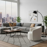 Contemporary grey modular sectional sofa with clean lines, deep cushioned seating, and neutral scatter cushions, styled in a sophisticated modern living room.