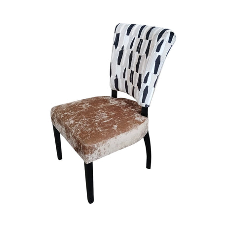 Contemporary dining chair featuring a black and cream abstract patterned upholstered backrest, a soft taupe velvet seat, and sleek black wooden legs, designed to add modern elegance and comfort to any dining space.