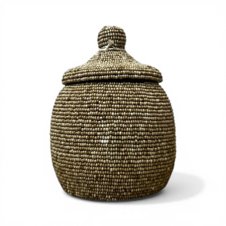Handcrafted decorative urn featuring a natural taupe beaded finish with a matching fitted lid and rounded finial. A refined artisan décor piece that adds texture, warmth, and contemporary African-inspired style to consoles, shelves, coffee tables, and luxury interiors.