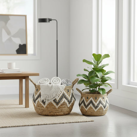 Two woven baskets with decorative patterns, one containing rolled-up towels, the other a potted plant, in a modern room.