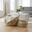 Woven baskets with geometric patterns on a wooden floor in a living room setting.