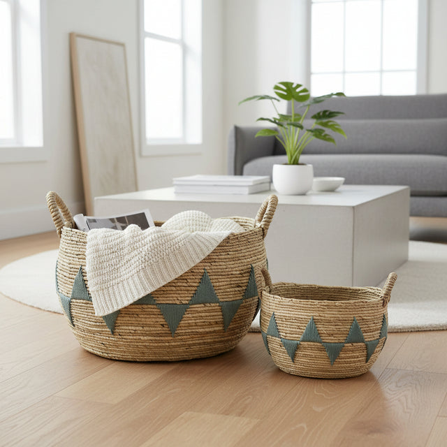 Woven baskets with geometric patterns on a wooden floor in a living room setting.