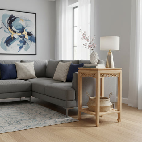 Modern living room with gray sectional sofa, wooden side table, and abstract art on wall.