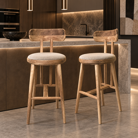 Two natural wood bar stools with curved backrests, round cream upholstered seats, tapered legs, and wooden footrests.