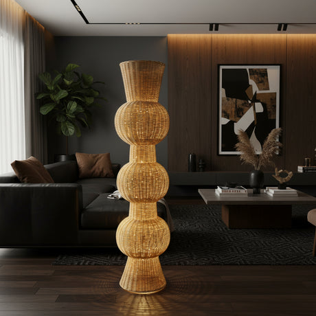 Tall handwoven sculptural floor vase with a natural wicker finish and a distinctive stacked bulb silhouette, styled in a contemporary living room. A striking statement décor piece that adds warmth, texture, and organic elegance to living rooms, entryways, boutique hotels, or covered outdoor spaces.