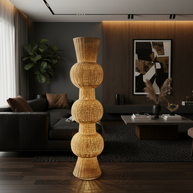 Tall handwoven sculptural floor vase with a natural wicker finish and a distinctive stacked bulb silhouette, styled in a contemporary living room. A striking statement décor piece that adds warmth, texture, and organic elegance to living rooms, entryways, boutique hotels, or covered outdoor spaces.