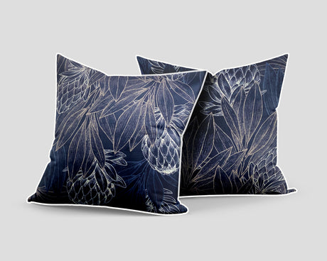 Set of three decorative navy blue scatter cushions featuring elegant protea flowers and botanical linework in soft silver tones, finished with contrasting light piping.