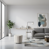 Ivory upholstered round ottoman with a minimalist design, ideal as a footrest, occasional seat, or modern accent piece for living rooms and bedrooms.