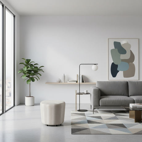 Ivory upholstered round ottoman with a minimalist design, ideal as a footrest, occasional seat, or modern accent piece for living rooms and bedrooms.