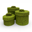 Set of three handcrafted cylindrical storage baskets with olive green wooden beads, matching fitted lids, and decorative beaded handles, perfect for stylish storage and adding vibrant natural texture to living rooms, bedrooms, or bathrooms.