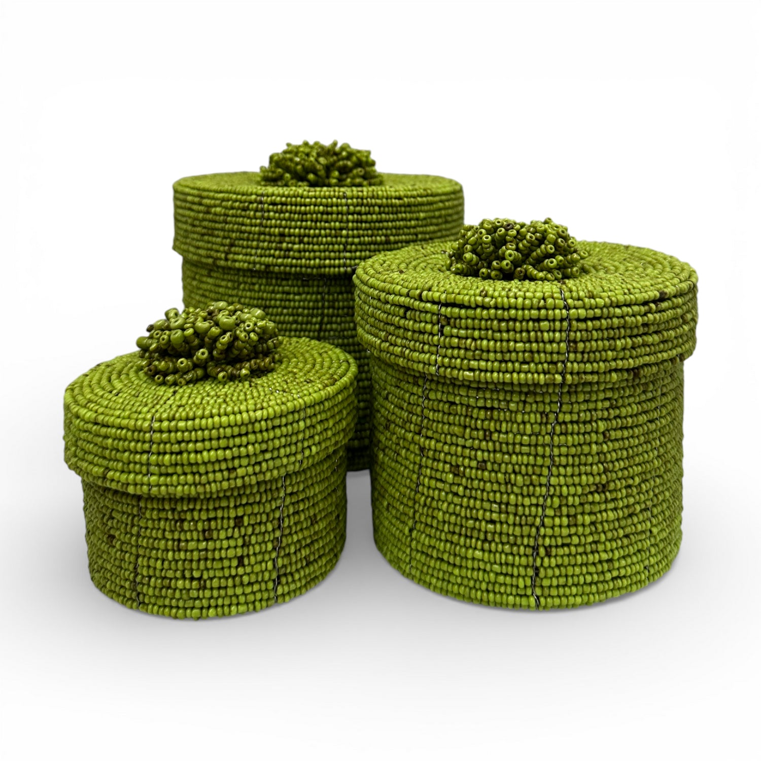 Set of three handcrafted cylindrical storage baskets with olive green wooden beads, matching fitted lids, and decorative beaded handles, perfect for stylish storage and adding vibrant natural texture to living rooms, bedrooms, or bathrooms.