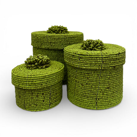 Set of three handcrafted cylindrical storage baskets with olive green wooden beads, matching fitted lids, and decorative beaded handles, perfect for stylish storage and adding vibrant natural texture to living rooms, bedrooms, or bathrooms.