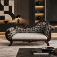 An ornate carved wooden loveseat with black-and-white patterned upholstery and a light beige seat cushion, styled in a luxurious modern living room setting.