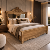 An ornate carved wooden bed frame with an integrated mirror, styled in a luxurious, warm-toned bedroom with beige bedding, textured pillows, and matching rug.