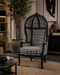 Luxurious high-back wingback chair featuring a hand-carved black wood frame, classic black and white houndstooth upholstery, sculpted arms, and elegant cabriole legs. A sophisticated statement chair for luxury, contemporary, and boutique-inspired interiors.