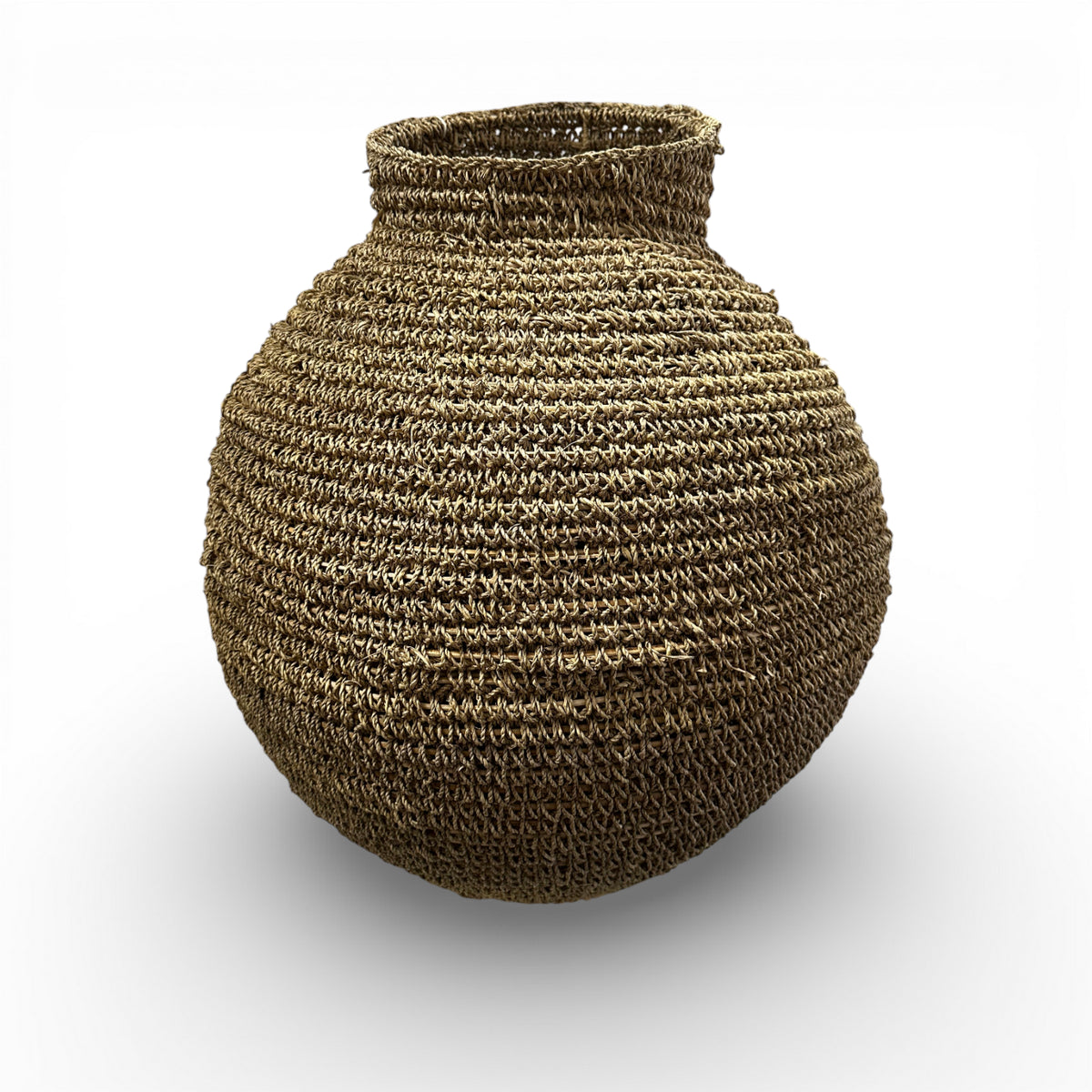Handcrafted round woven natural fibre basket with a sculptural bulb shape and narrow opening, ideal for adding organic texture to modern interiors.