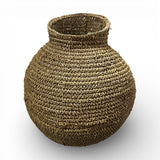 Handcrafted round woven natural fibre basket with a sculptural bulb shape and narrow opening, ideal for adding organic texture to modern interiors.