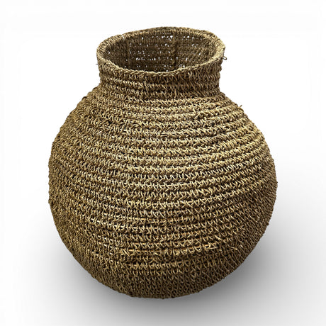 Handcrafted round woven natural fibre basket with a sculptural bulb shape and narrow opening, ideal for adding organic texture to modern interiors.