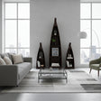 Set of three handcrafted canoe-shaped display shelves in a dark stained wood finish, styled with books, candles, framed art, and decorative accessories in a contemporary living room.