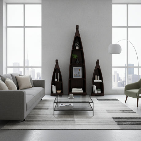 Set of three handcrafted canoe-shaped display shelves in a dark stained wood finish, styled with books, candles, framed art, and decorative accessories in a contemporary living room.