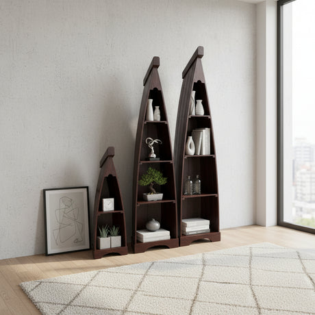Set of three handcrafted canoe-shaped display shelves in a dark stained wood finish, styled with books, candles, framed art, and decorative accessories in a contemporary living room.