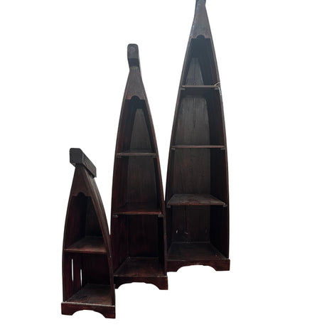 Set of three handcrafted canoe-shaped display shelves in dark stained solid wood, featuring open display compartments in three different sizes, shown together against a white background.
